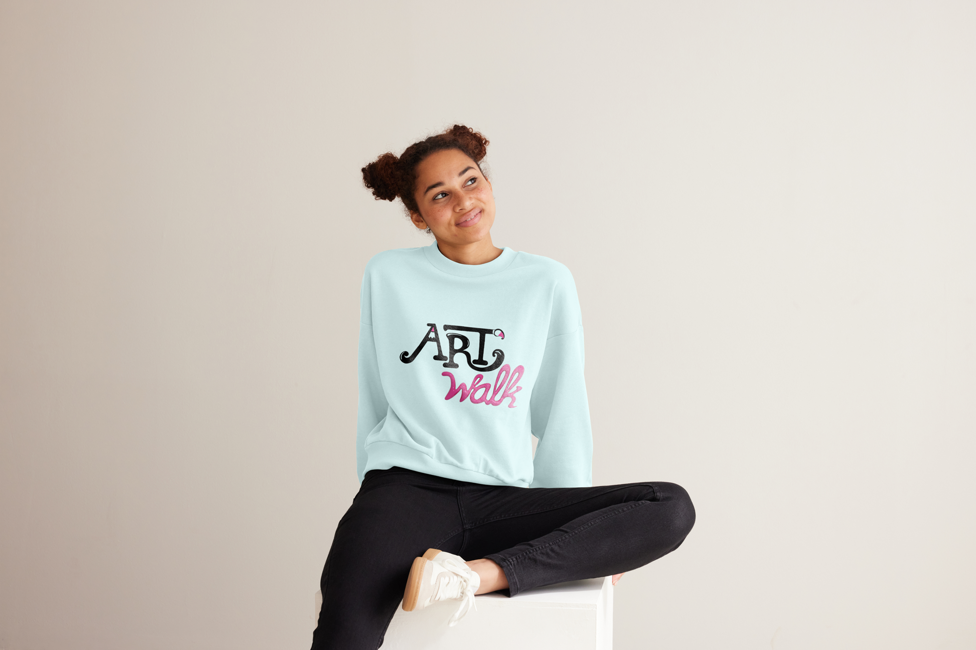 a girl wearing a pink and light blue ArtWalk sweatshirt